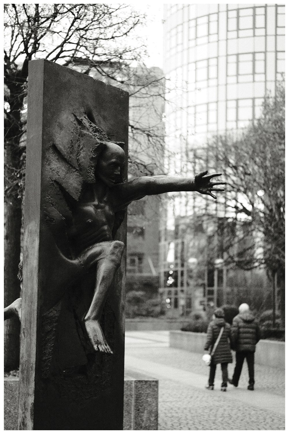 a black and white photo of a statue of a monkey