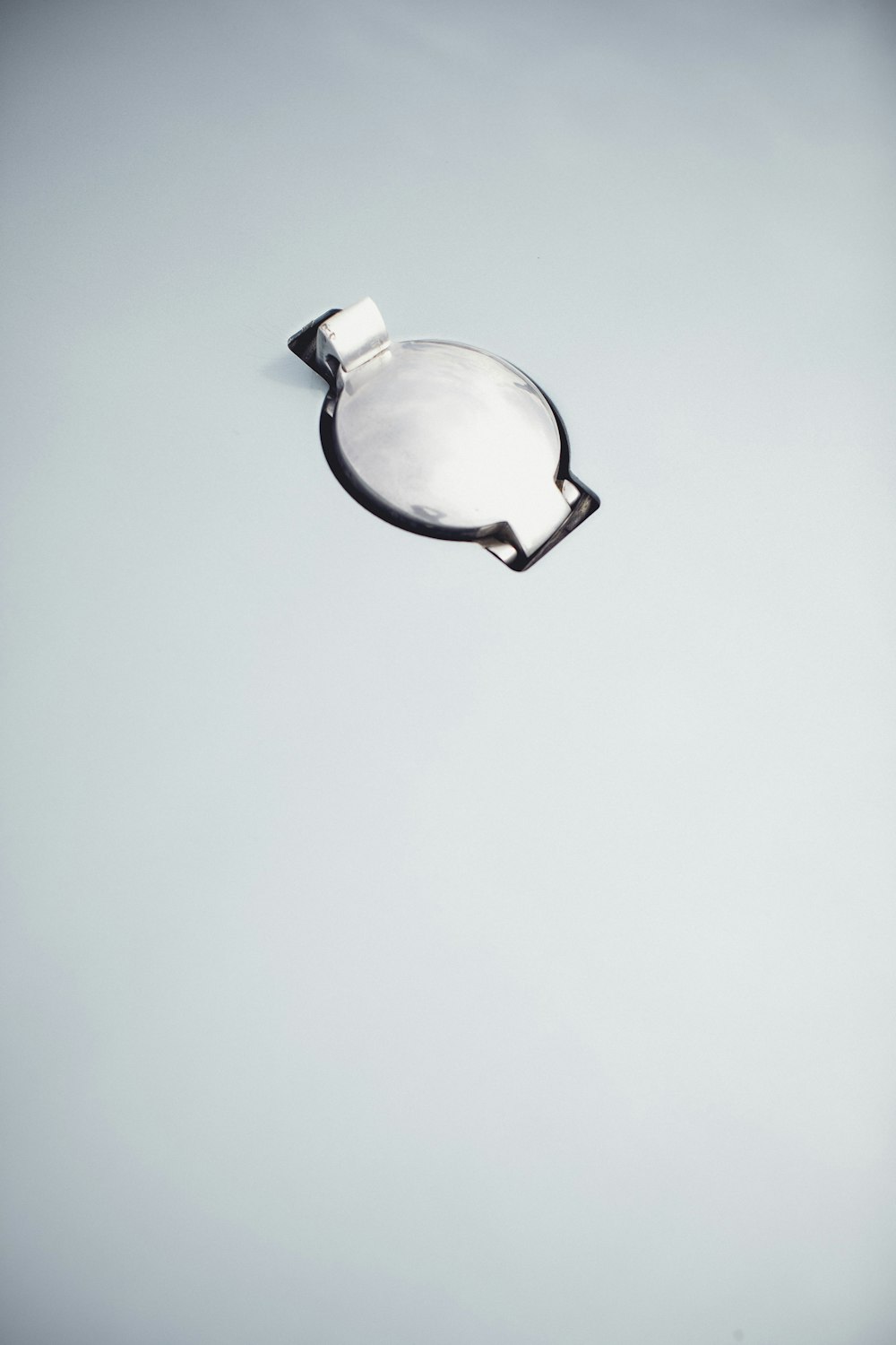 a white object floating in the air on a gray background