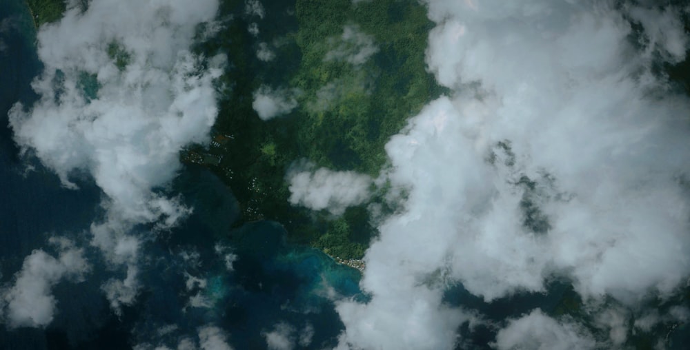 an aerial view of clouds over a body of water