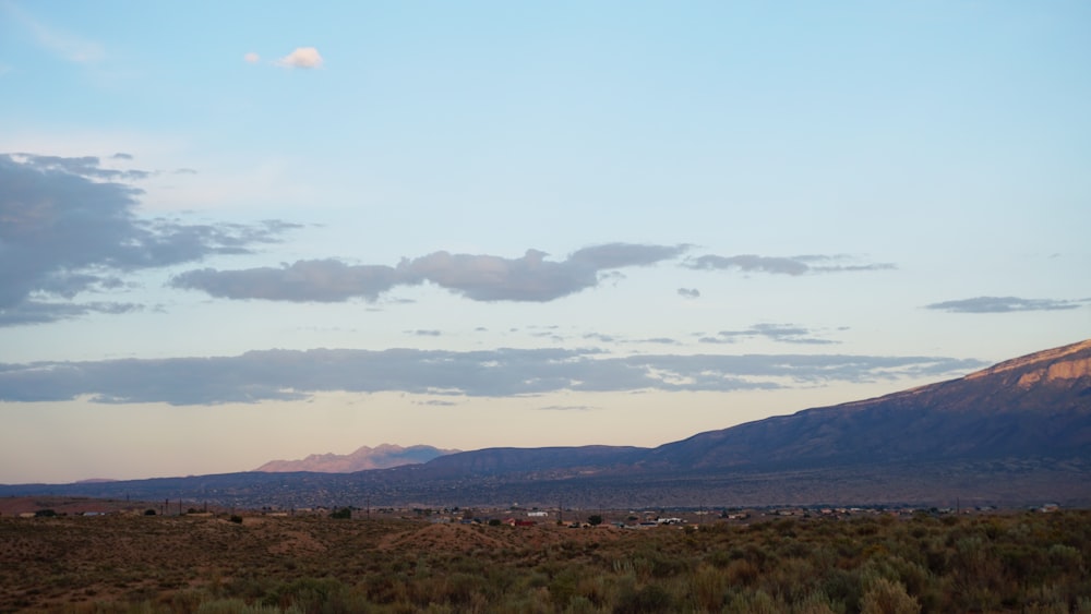 a view of a mountain with clouds in the sky