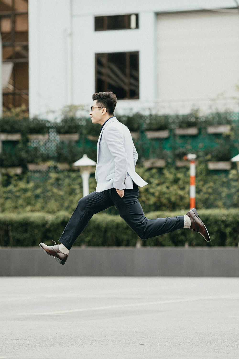 a man in a suit is running in the street