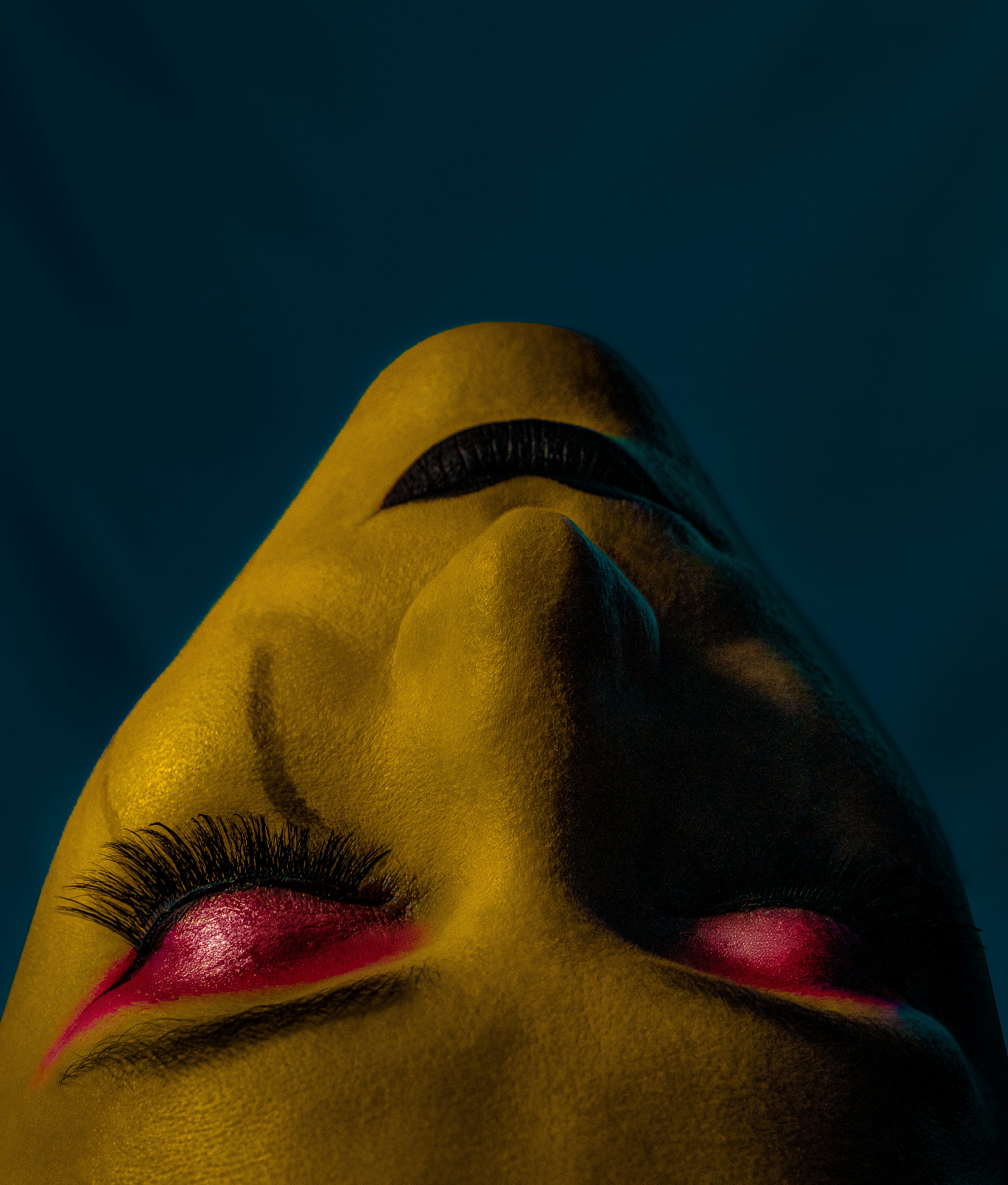 a close up of a person's face with red eyes
