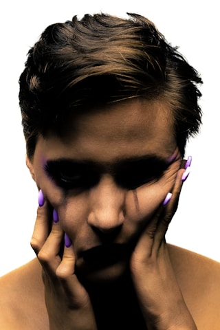 a man holding his hands to his face