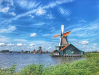 a windmill sitting on top of a body of water