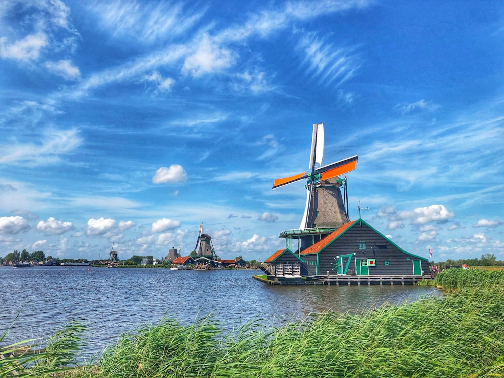 a windmill sitting on top of a body of water