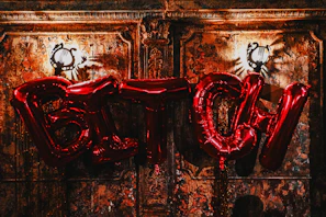 Metal letter wall hanging spelling out a cozy word in brushed gold finish