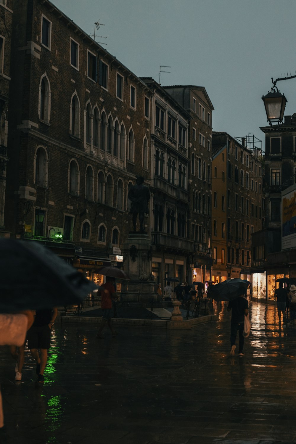 a group of people walking down a street holding umbrellas