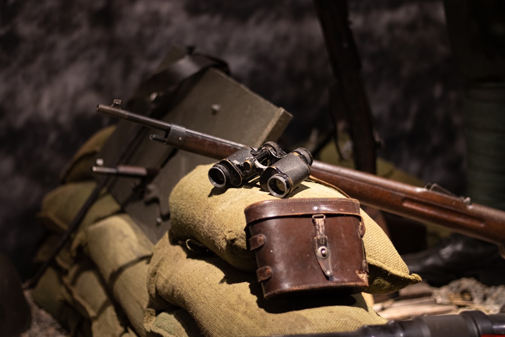 a couple of guns sitting on top of a bag