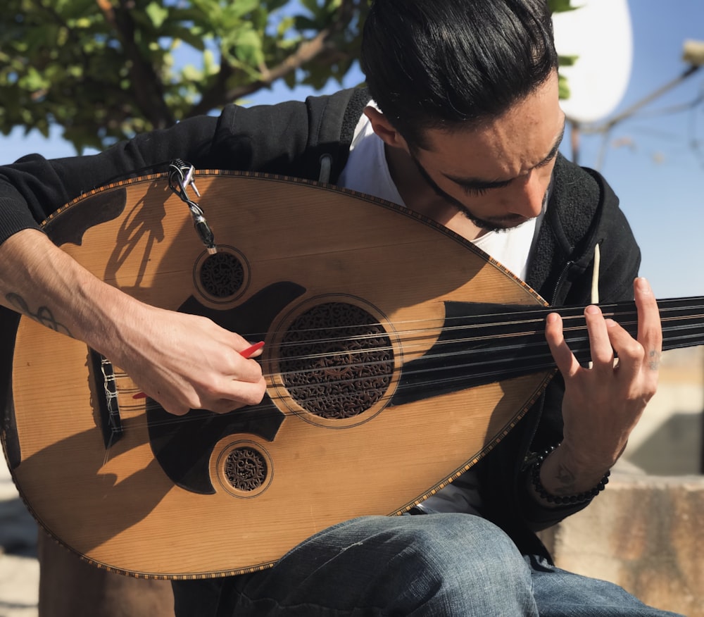 a man holding a wooden instrument in his hands