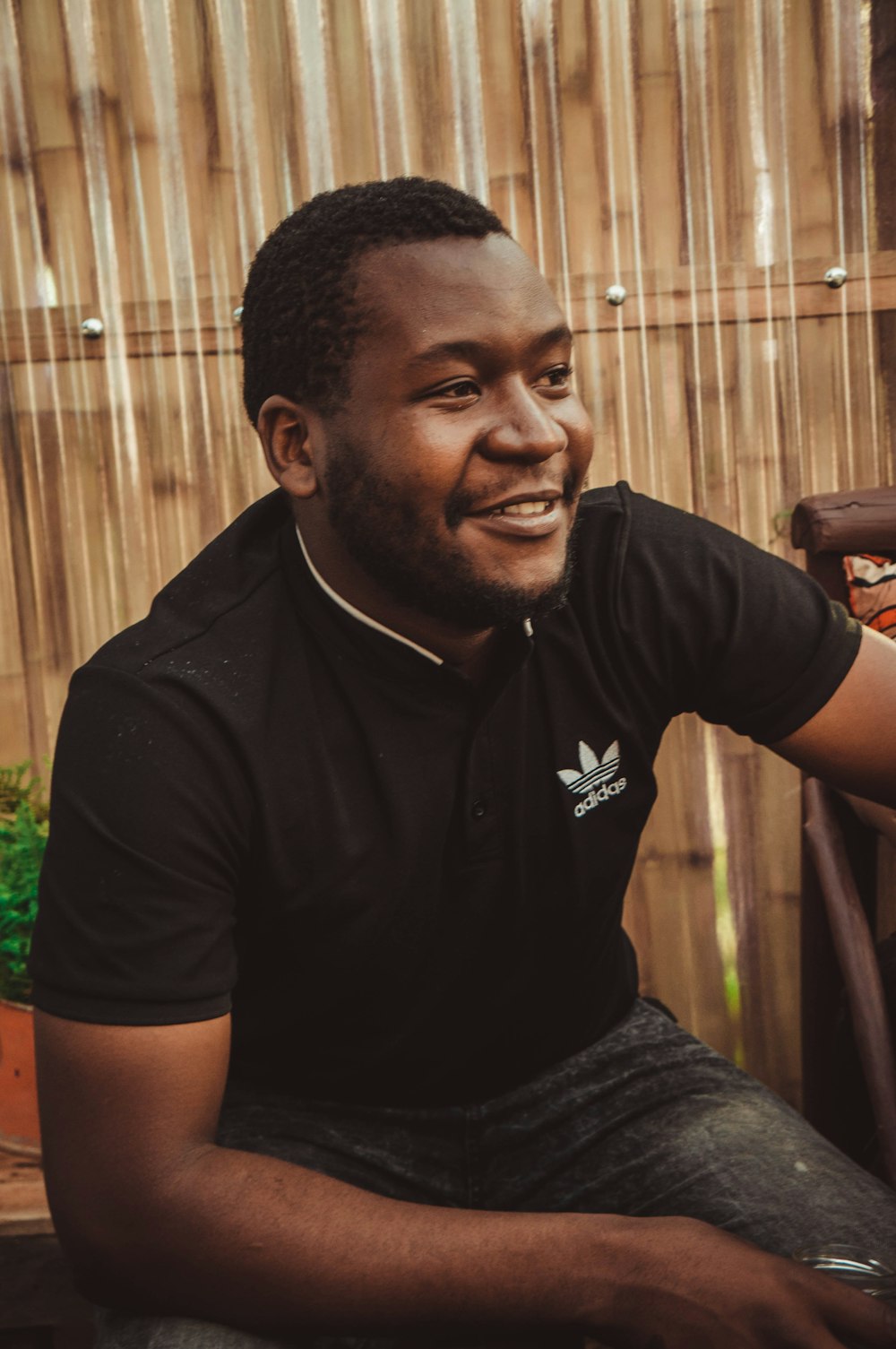 a man sitting on a chair smiling for the camera