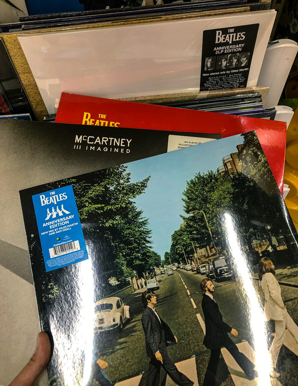 a person holding a record with the cover of the beatles album