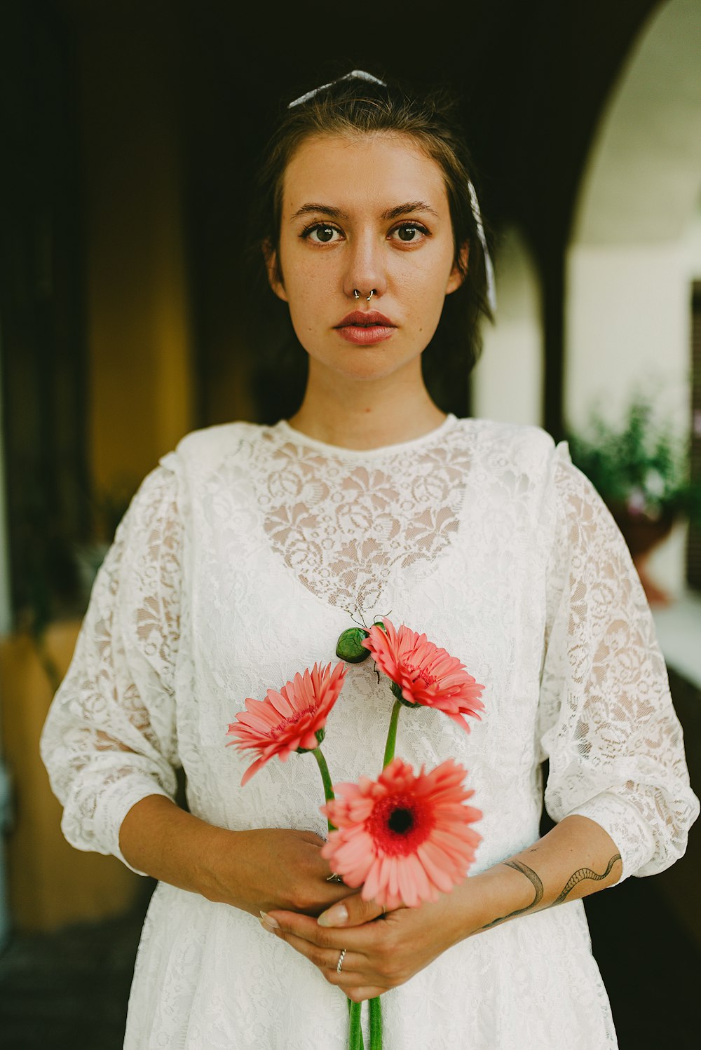 a woman in a white dress holding a bouquet of flowers