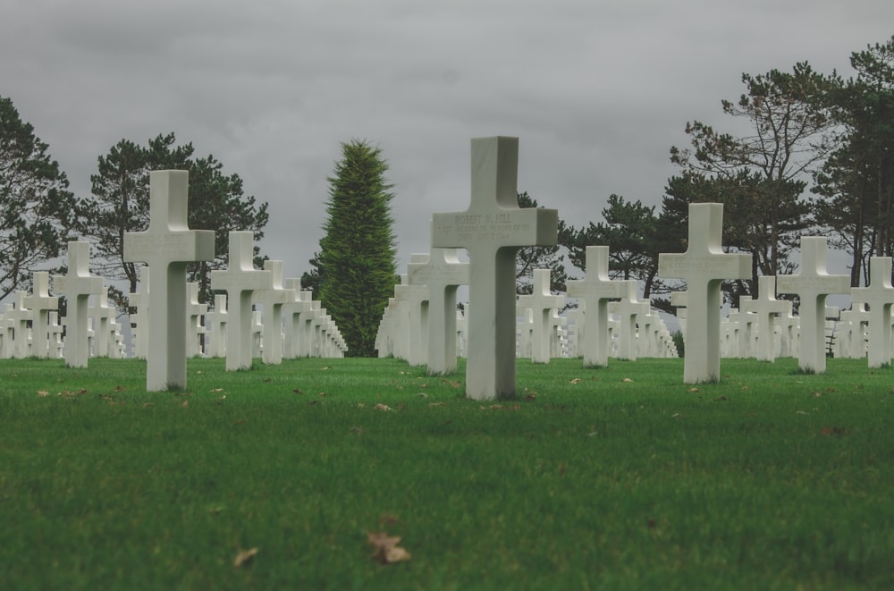 a cemetery with many headstones and crosses