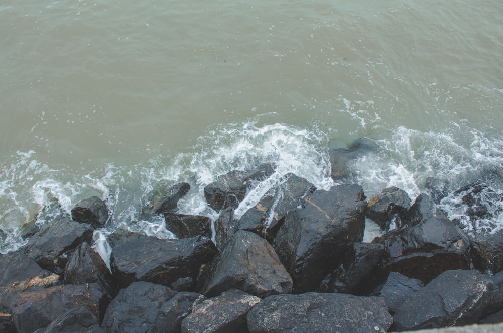 a bunch of rocks that are by the water