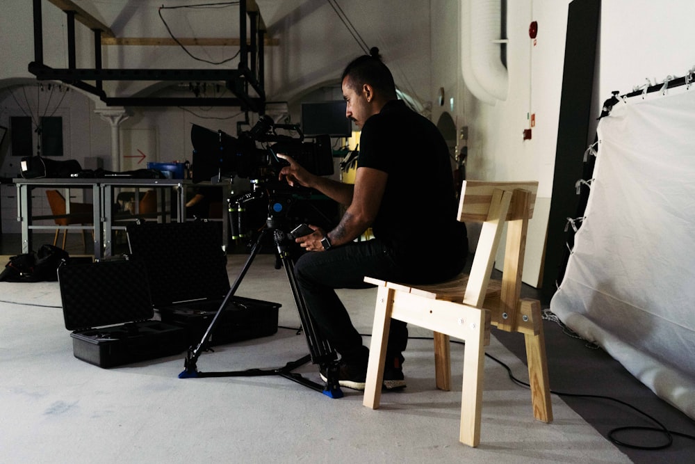 a man sitting in a chair in front of a camera
