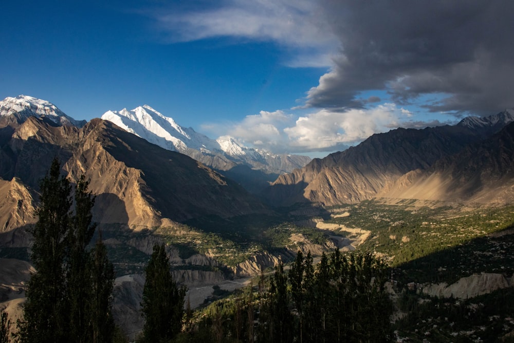 a view of a valley with mountains in the background