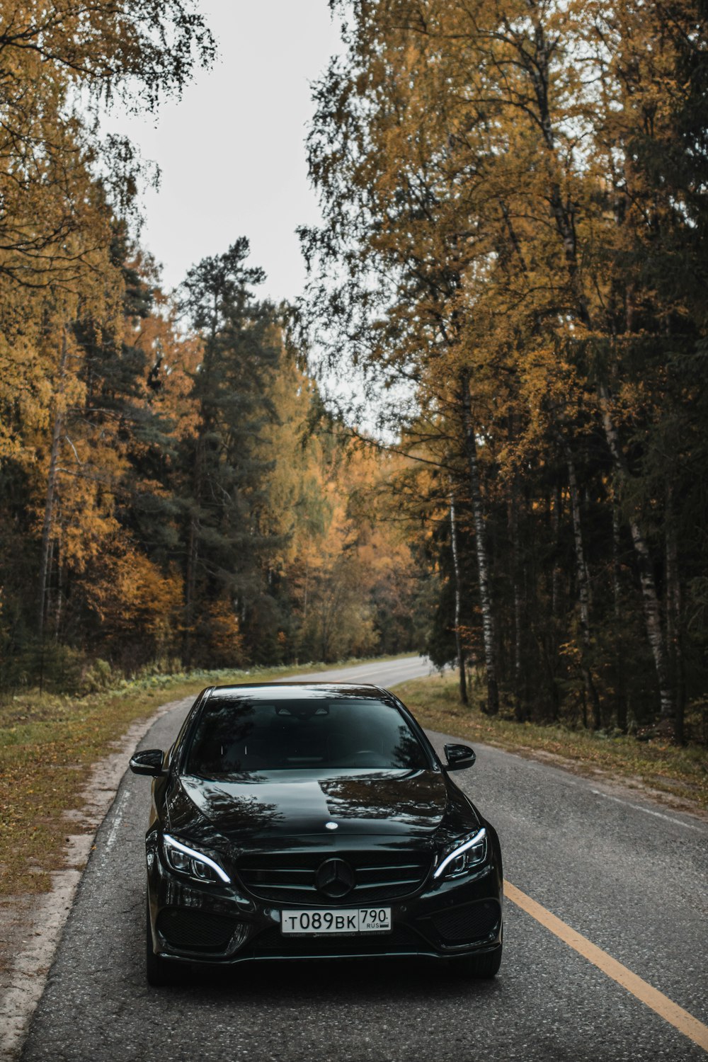 a black car parked on the side of a road