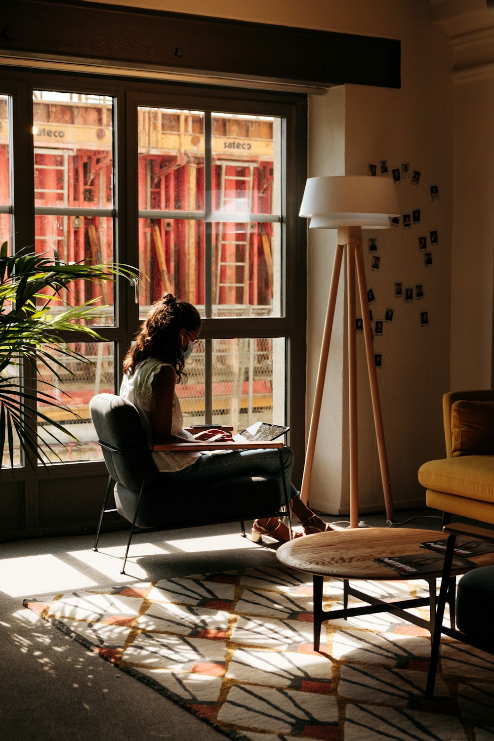 a woman sitting in a chair in front of a window