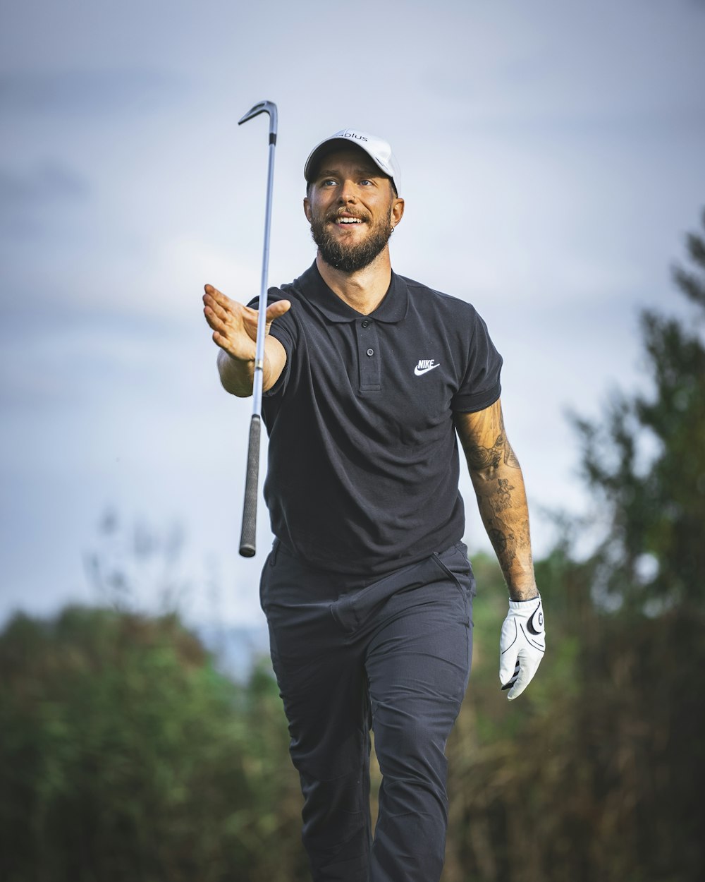 a man holding a golf club and a golf ball