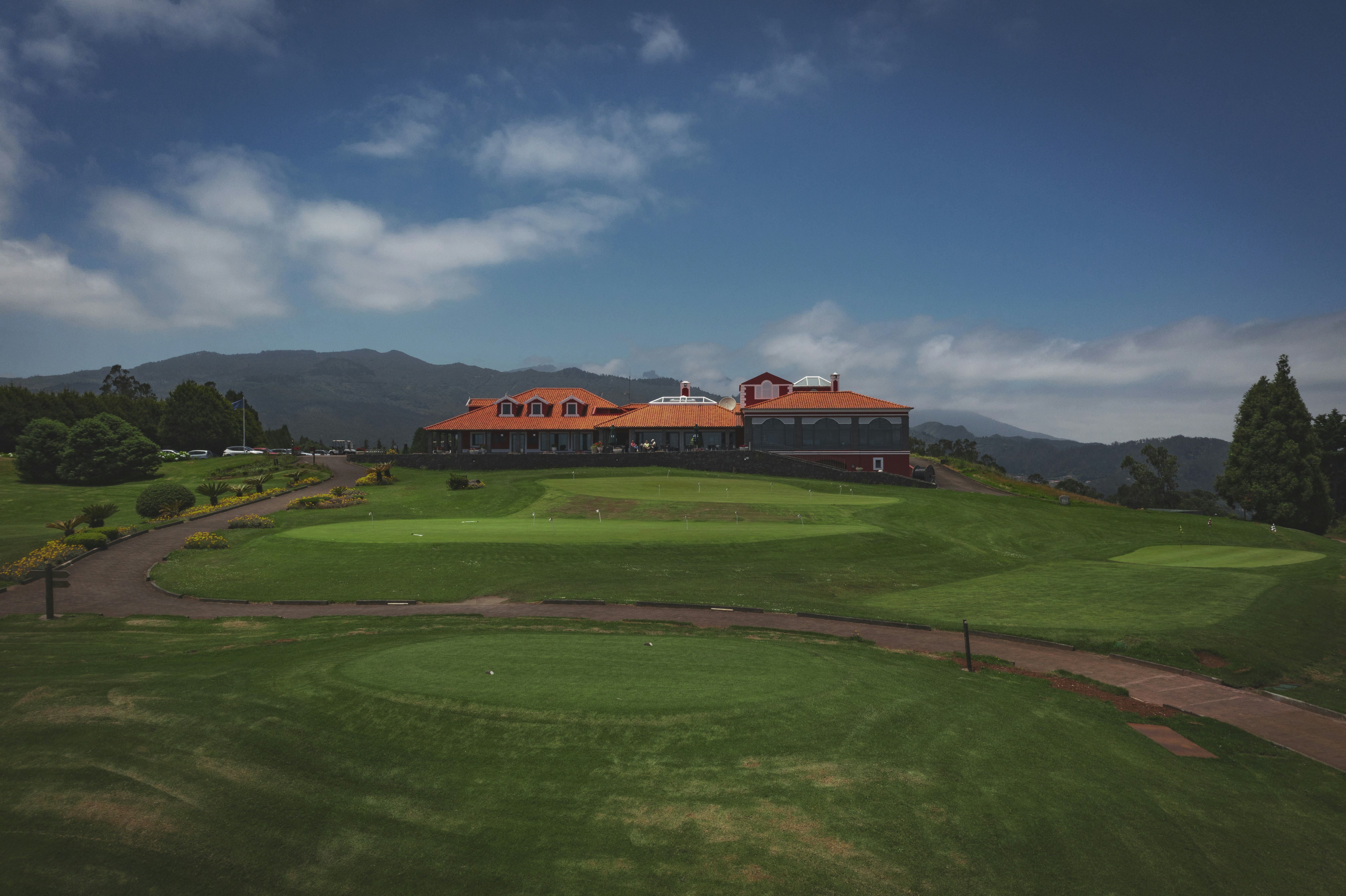 a golf course with a large building in the background