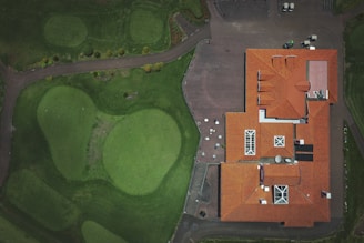 an aerial view of a house with a red roof