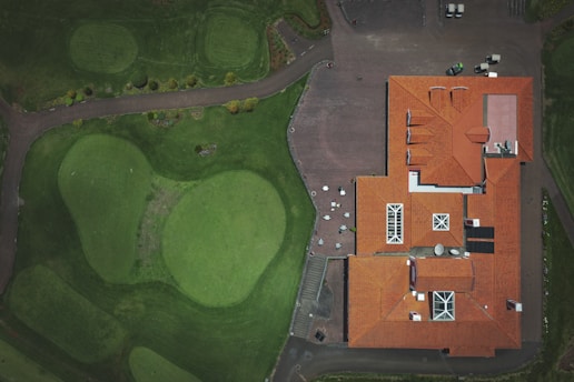 an aerial view of a house with a red roof