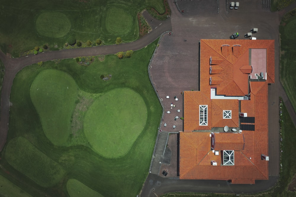 an aerial view of a house with a red roof