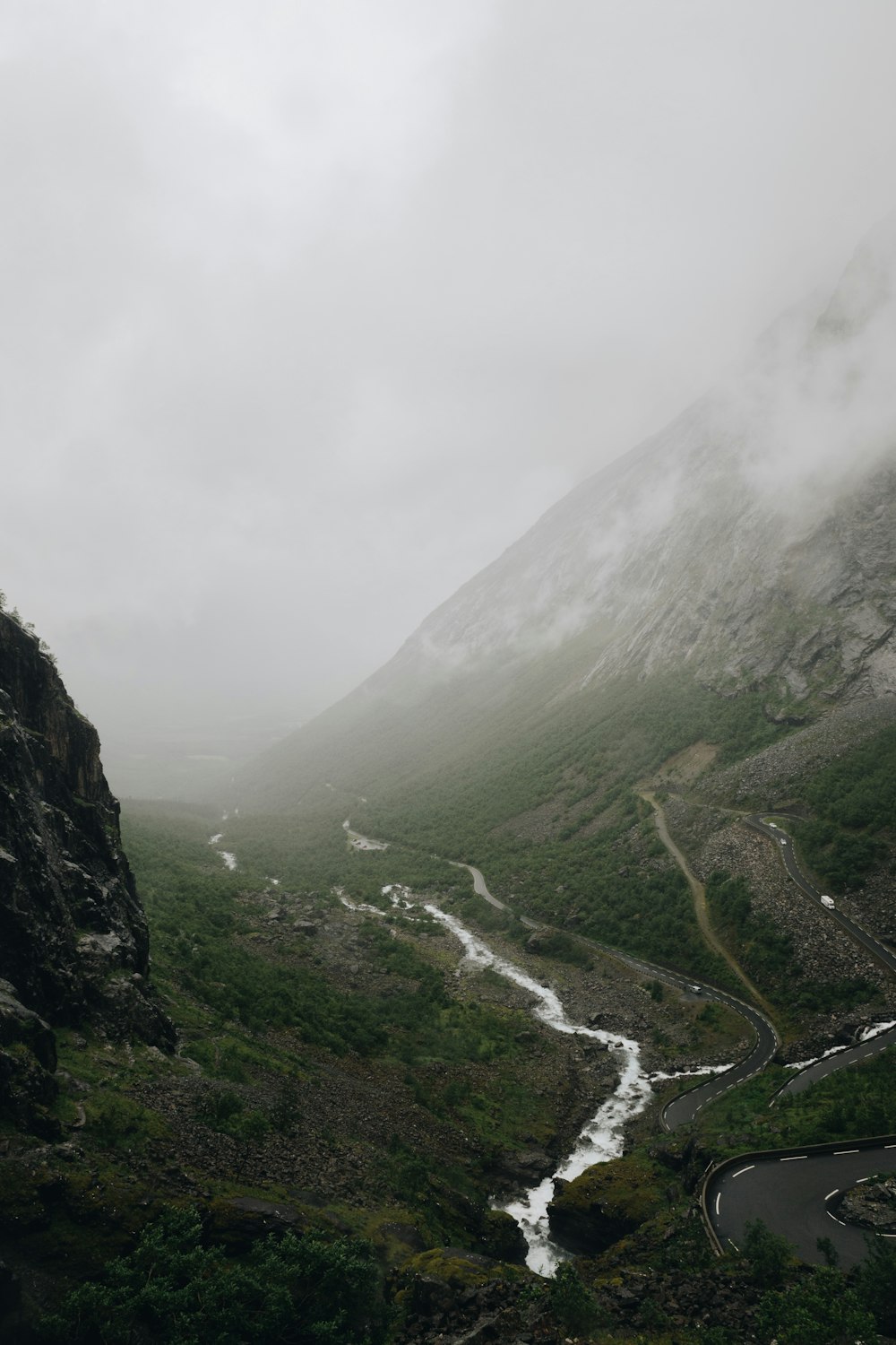 a river running through a lush green valley