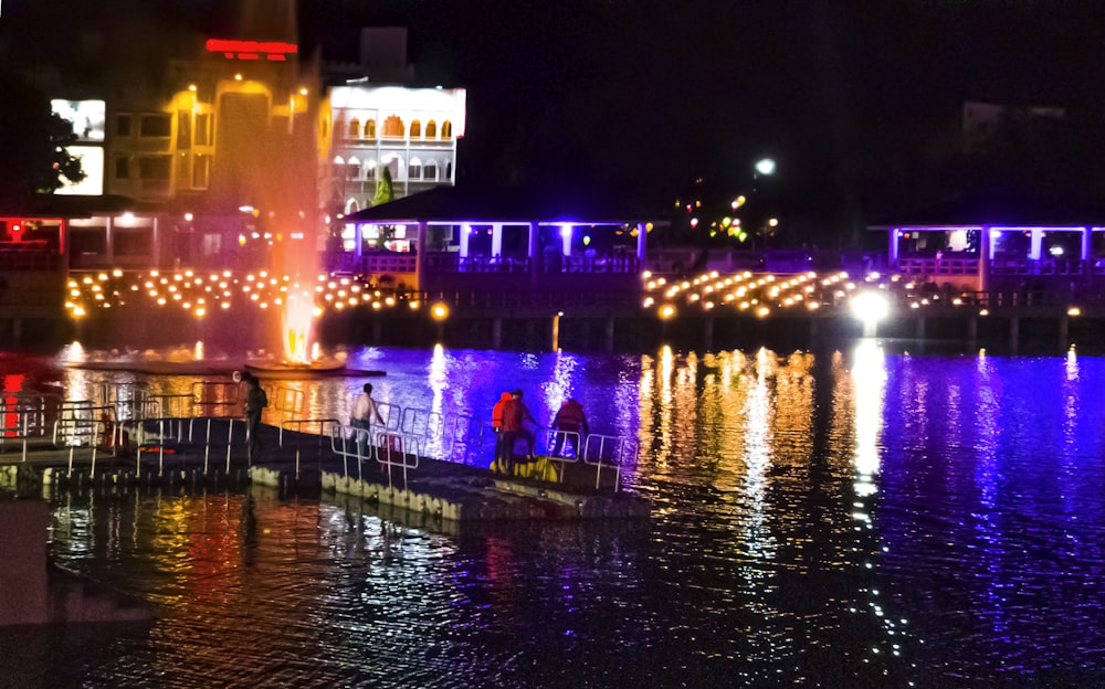 a couple of people that are standing on a boat in the water