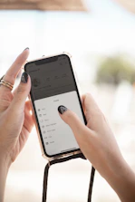 a person holding a cell phone in their hand