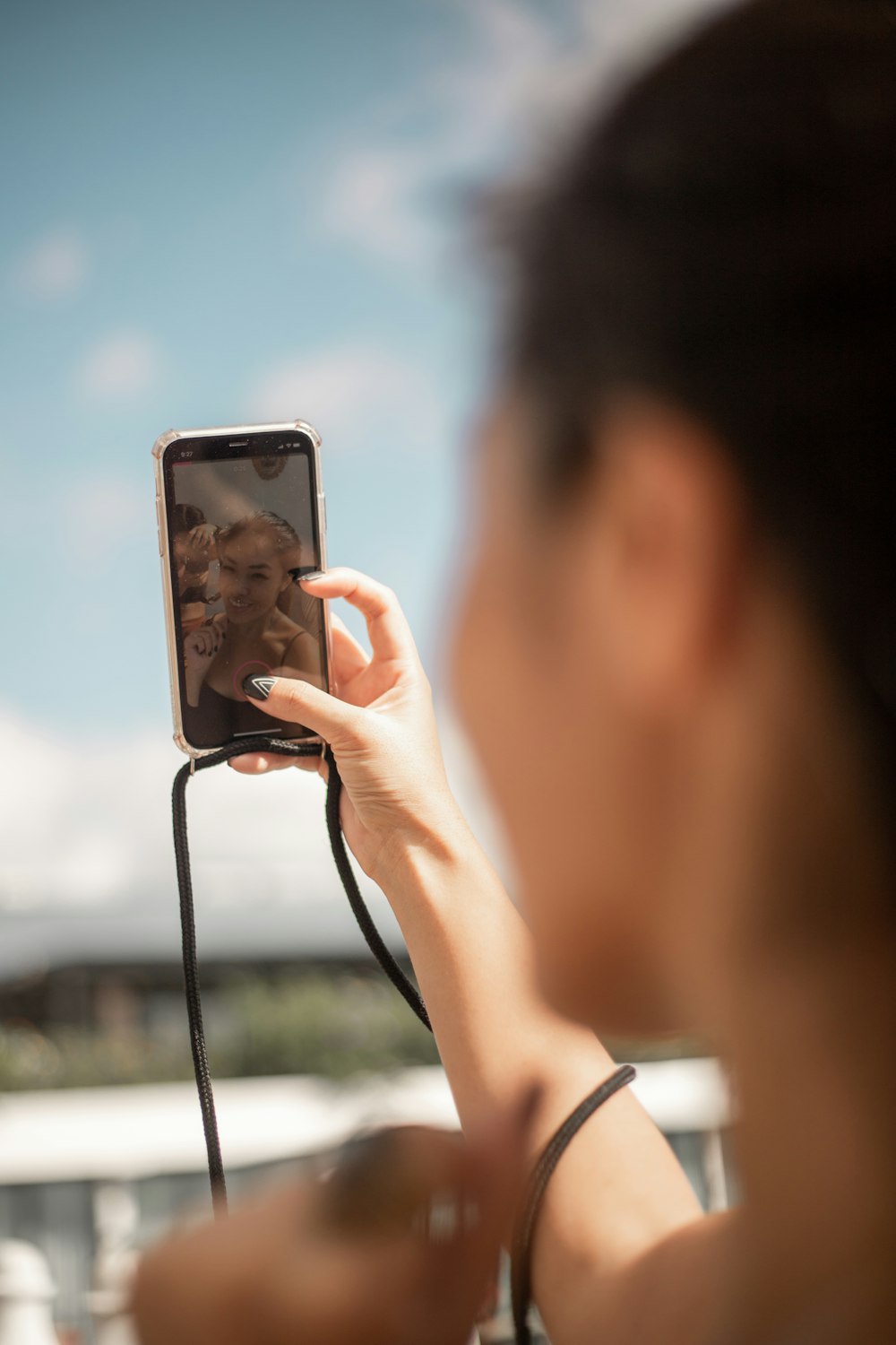 a woman taking a picture of herself with her cell phone