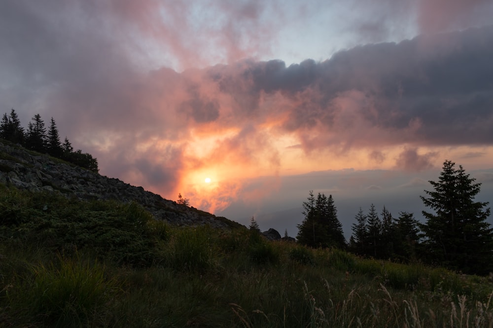 the sun is setting on a cloudy day