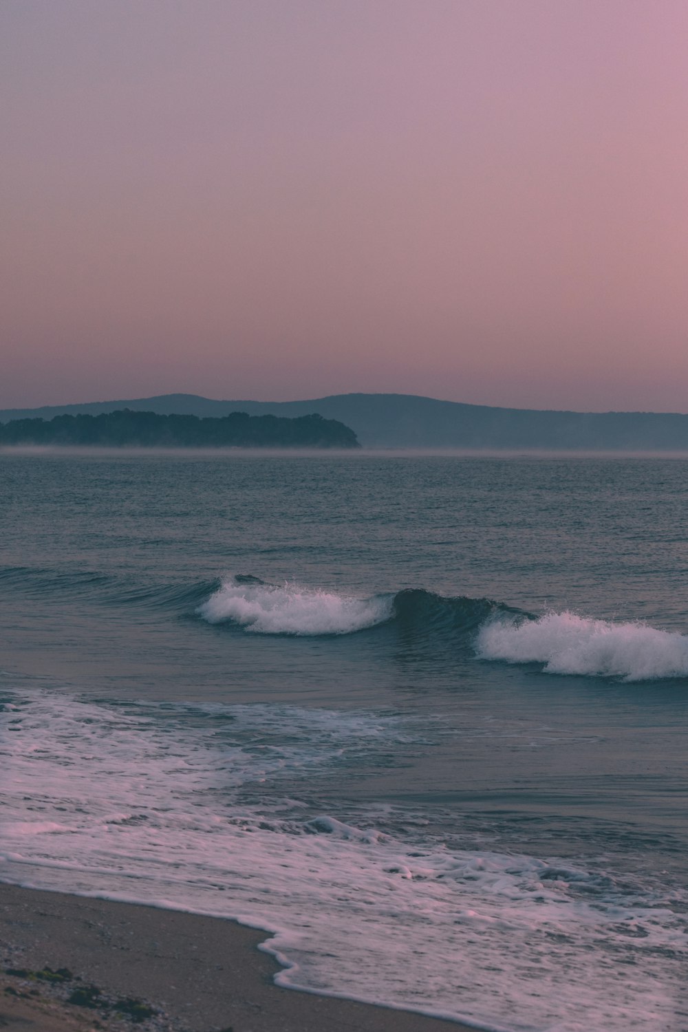 a person riding a surfboard on a wave in the ocean