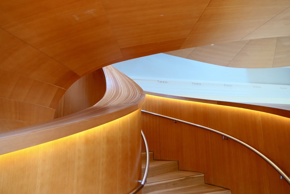 a curved wooden staircase in a building