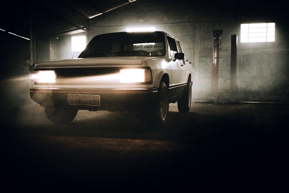 a white truck parked in a dark garage