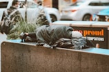 a homeless man sleeping on a city street