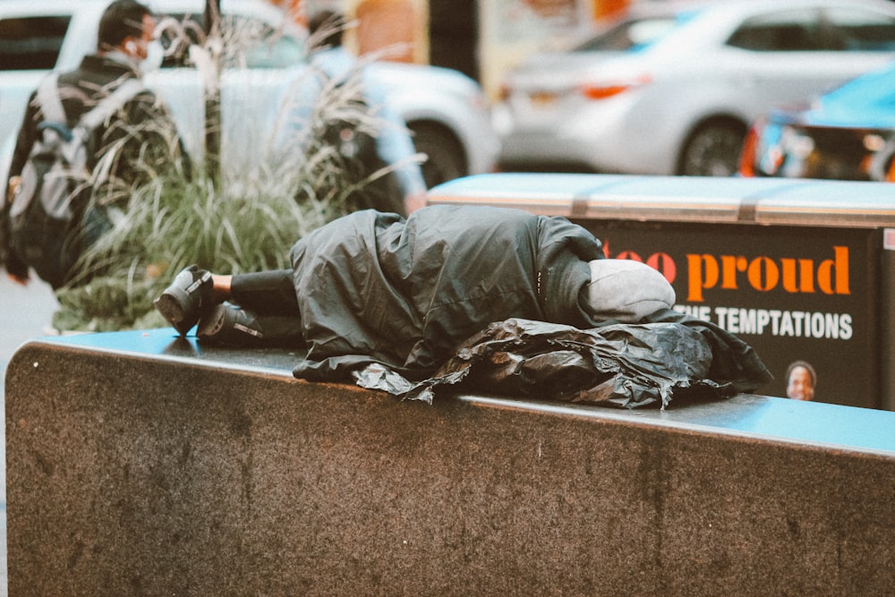 a homeless man sleeping on a city street