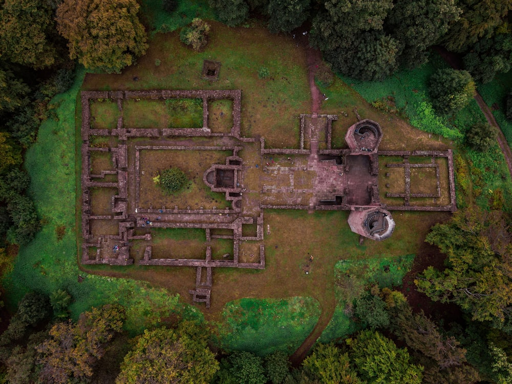 an aerial view of a building in the middle of a forest