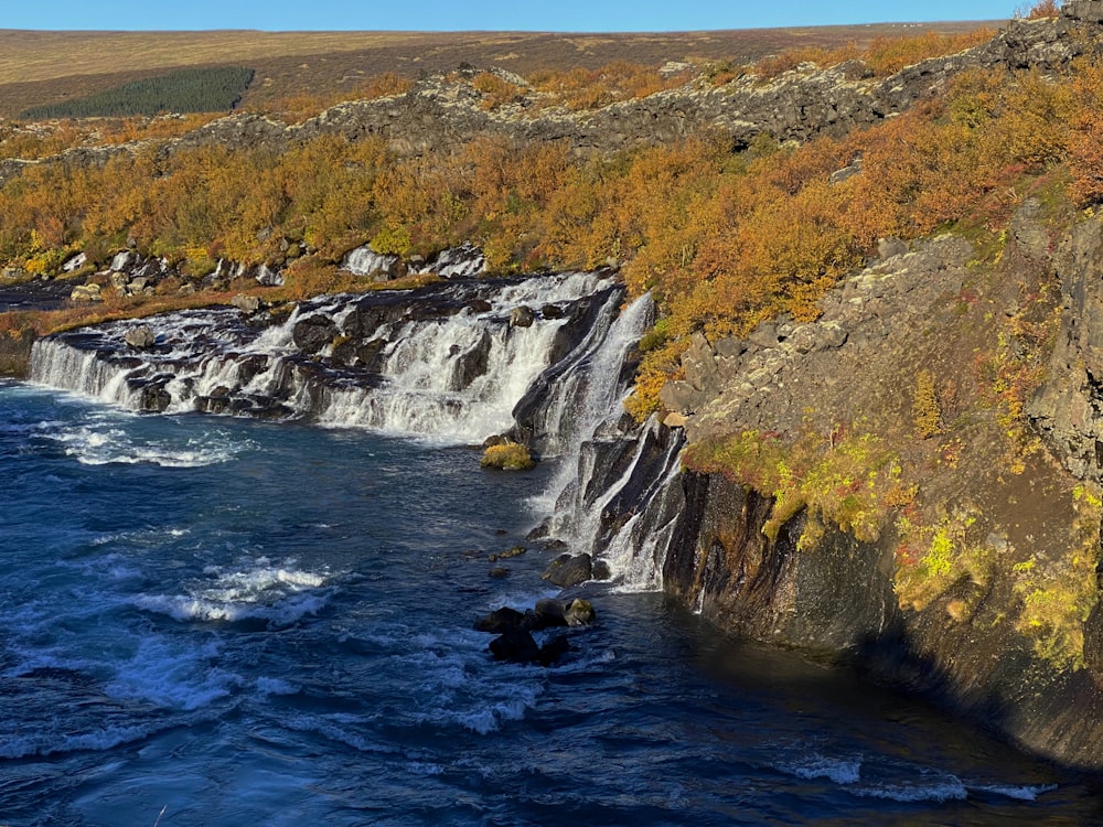 a waterfall in the middle of a body of water