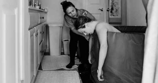 a couple of women standing next to each other in a bathroom