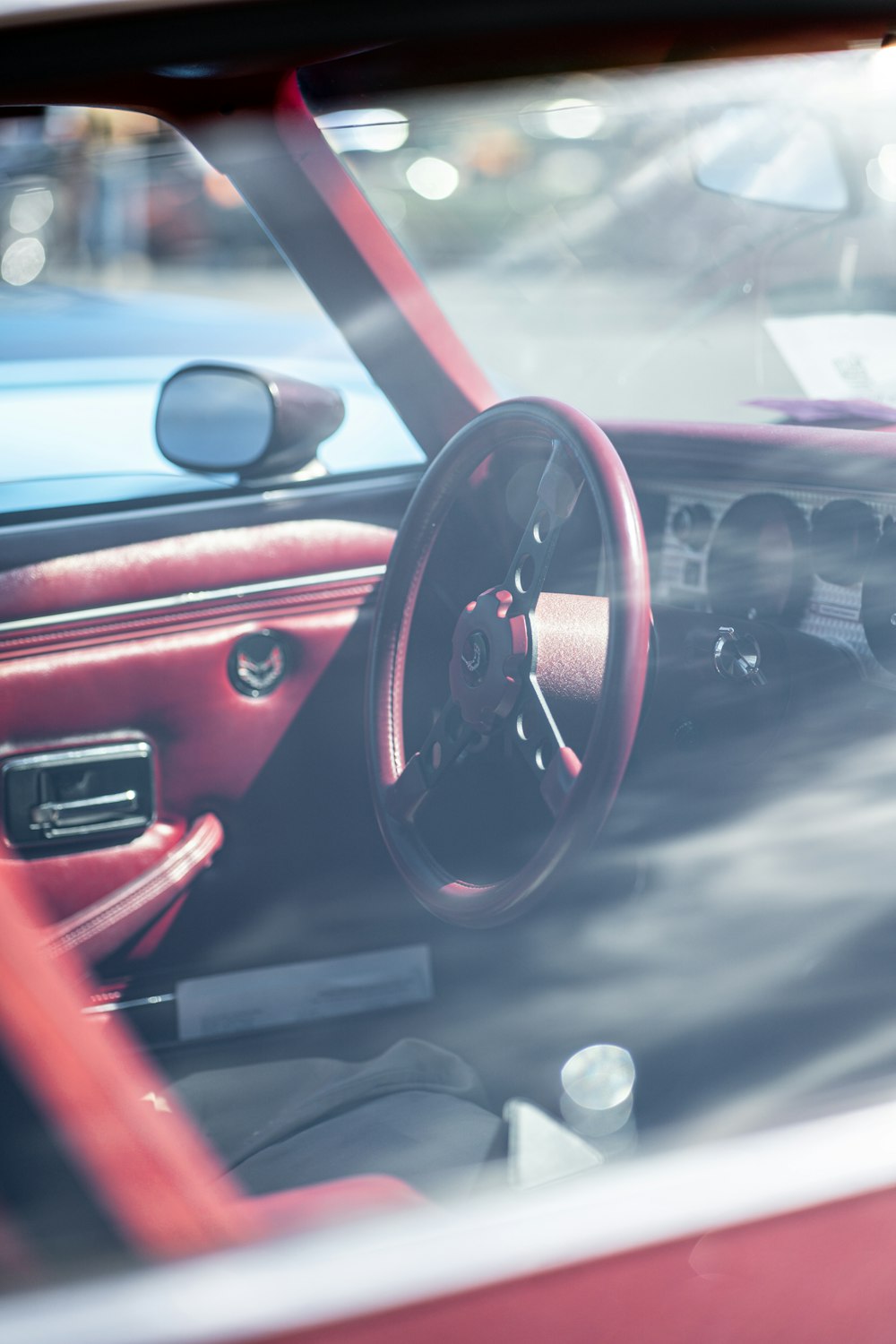 a red car with a steering wheel and a dashboard