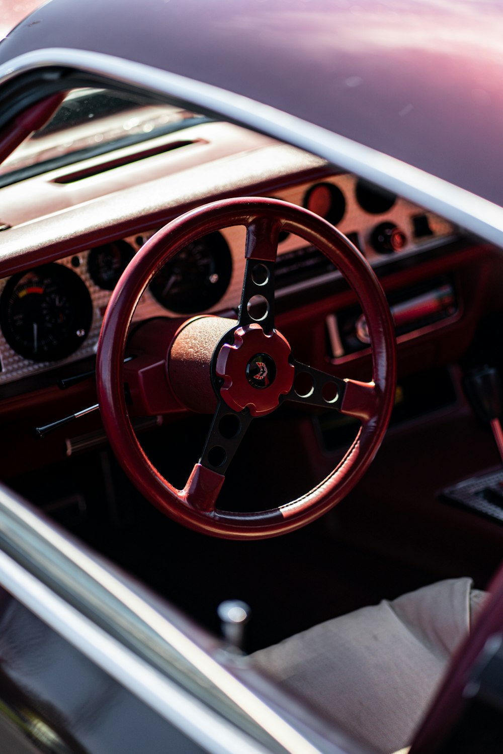 the interior of a car with a steering wheel and dashboard