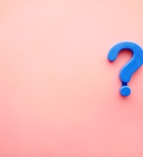 a blue question mark on a pink background