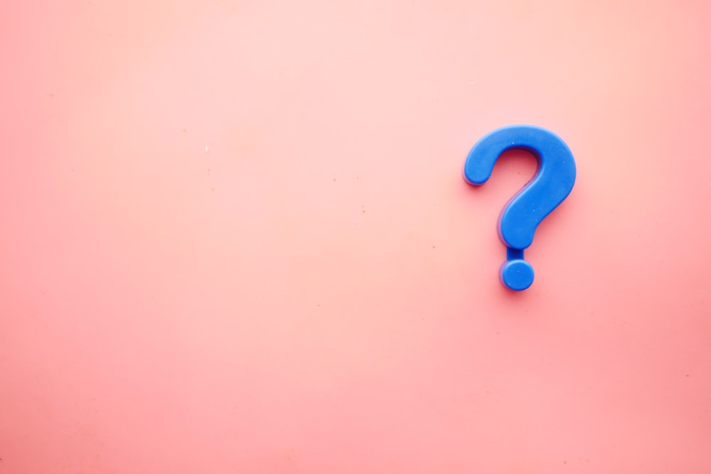 Blue question mark on pink background