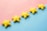 a row of yellow stars sitting on top of a blue and pink surface