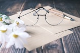 a pair of glasses sitting on top of a piece of paper