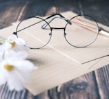 a pair of glasses sitting on top of a piece of paper