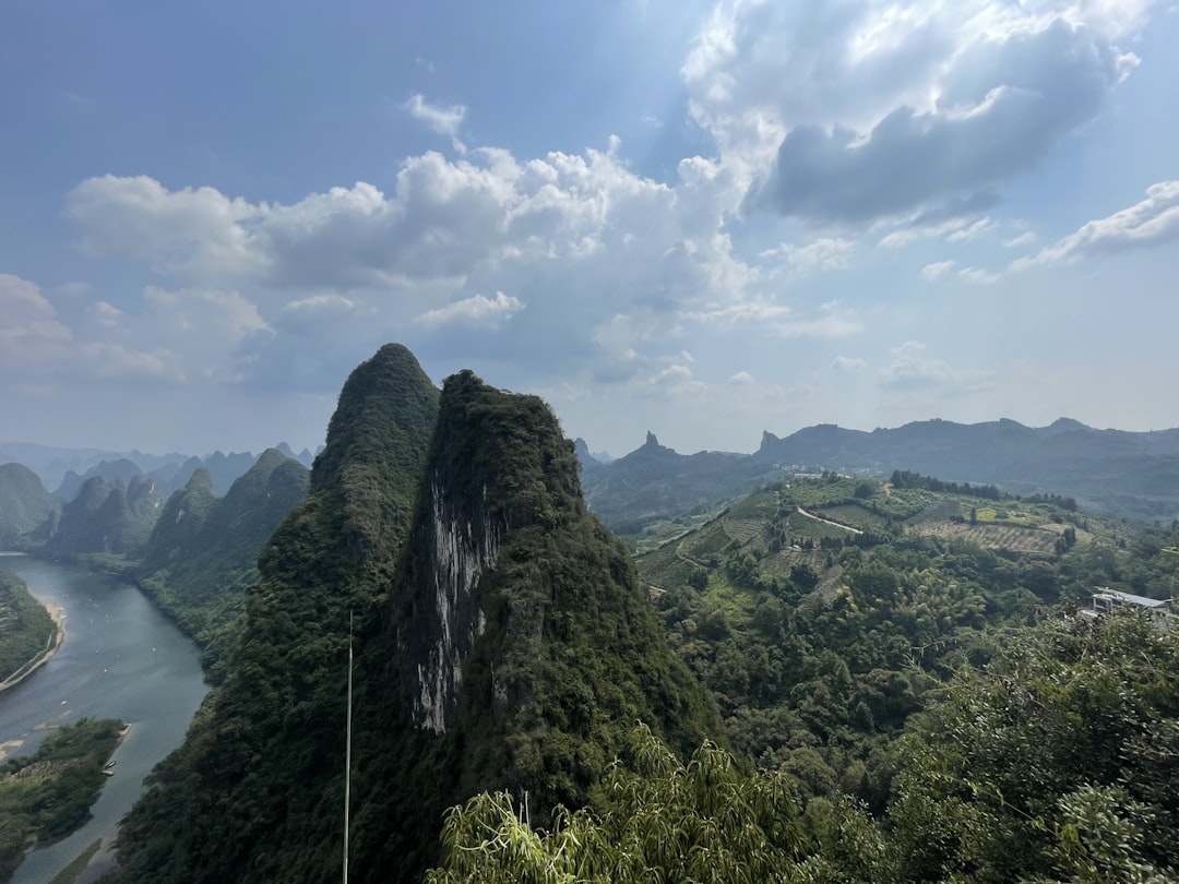 a scenic view of a river and mountains,
