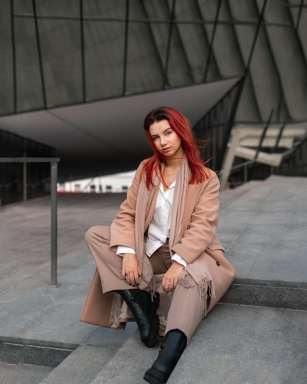 a woman sitting on a bench talking on a cell phone