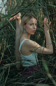 a woman standing in a field of tall grass